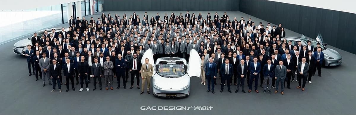 The GAC Design team gathered around a concept car